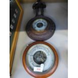 An early 20th century aneroid barometer and a similar barometer