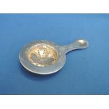 A 19th Century Russian silver tea strainer having brightcut decoration,  bearing Moscow hallmarks