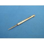 A 9ct gold propelling tooth pick having engine turned decoration