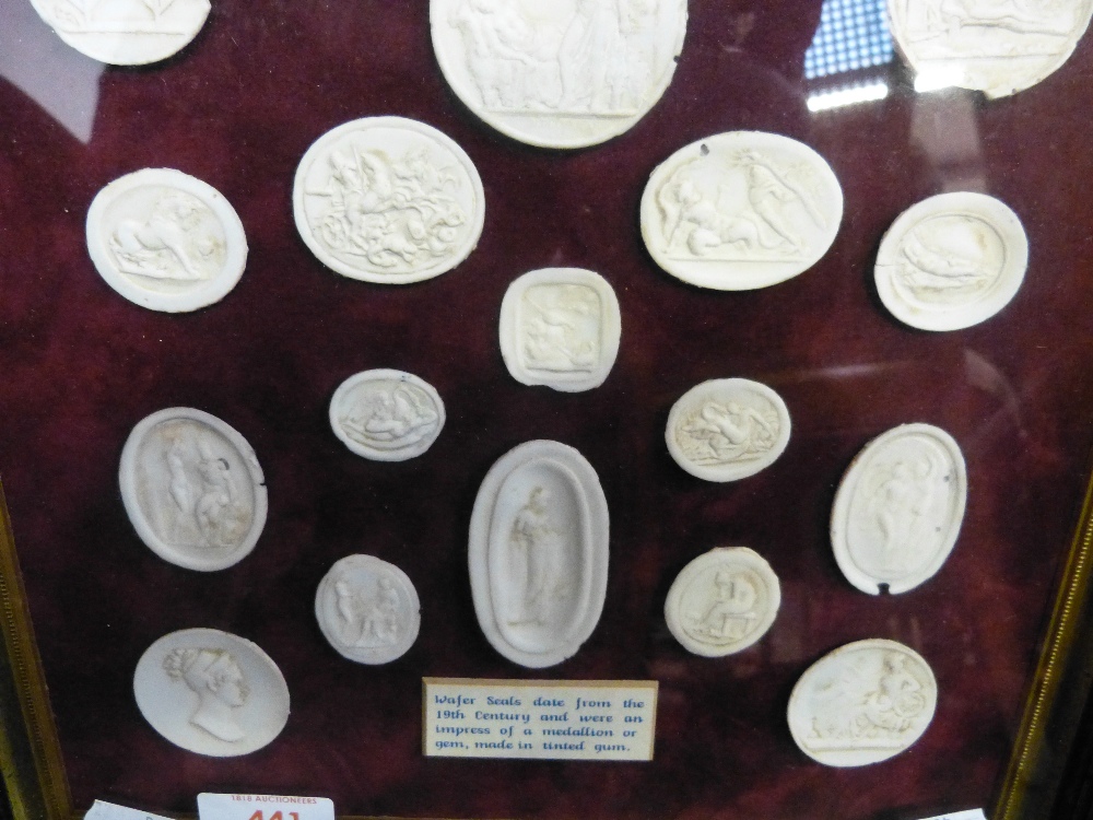 A framed collection of 19th century wafer seals impressed as Medallions