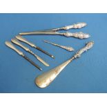 A selection of HM silver handled dressing table items including manicure tools, glove stretchers and