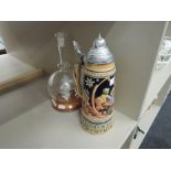 A beer stein and ship in bottle