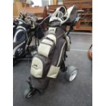 A motorised gold trolley and selection of clubs