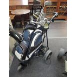 A motorised golf trolley and selection of clubs including King Cobra