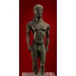 A spectacular Greek bronze figure of a striding Kouros 6th century BC; 12 cm (4,76 in) high; An