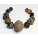 Thirteen Villanovan impasto necklace beads 9th-8th century BC; 4 cm (1,57 in) max high; 5 cm (1,96