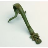 A Greek bronze olpe handle Early 4th century BC; 14,2 cm (5,59 in) high; The lower attachment