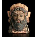 An Etruscan polychrome terracotta antefix 5th century BC; 15,7 cm (6,18 in) high; Modelled in the