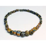 Fifty Mediterranean glass eye and spiral necklace beads 6th-2nd century BC; 49 cm (19,29 in) long;