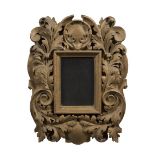 A CARVED GILTWOOD WALL MIRROR, the recta