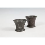 A PAIR OF 16TH CENTURY BRONZE MORTARS OF CIRCULAR FORM with flared neck and a Tudor rose cast in low