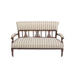 AN EDWARDIAN MAHOGANY FRAMED SETTEE, wit