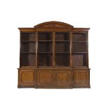 A VICTORIAN OAK BREAKFRONT BOOKCASE, the