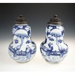 A PAIR OF CHINESE BLUE AND WHITE VASES AND COVERS, late 19th century, each pear shaped body fitted