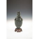 A CHINESE SPINACH JADE VASE AND COVER, late Qianlong, of flattened ovoid shape, the top surmounted