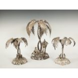 A VICTORIAN SILVER PLATED THREE PIECE TABLE CENTRE PIECE, comprising of a group modelled as an