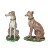 A LARGE PAIR OF POLYCHROME GLAZED POTTERY WARE MODELS OF DOGS, seated on oval green bases. 84cm