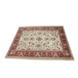 AN ATTRACTIVE ZIEGLER PATTERN WOOL CARPET, woven with intertwined tendrils and flowerheads on a