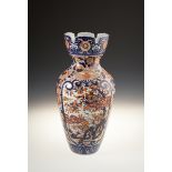 A JAPANESE IMARI PARCEL VASE of baluster form, with serrated rim, the body decorated in