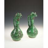 A PAIR OF 19TH CENTURY TURKISH CANAKKALE EWERS, the mottled green earthenware with applied floral