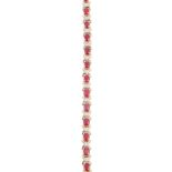 A diamond and ruby bracelet, composed of a continuous row of alternating oval mixed-cut rubies and