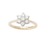 A diamond daisy cluster ring by Appleby, Dublin, composed of round brilliant-cut diamonds, within an