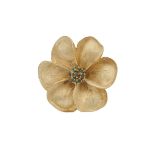 An 18 carat gold flower brooch, each petal with fine grain texture to a fine millegrain edge and a