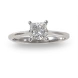 A diamond single-stone ring, composed of a princess-cut diamond within a four-claw setting to a