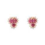 A pair of diamond and ruby earrings, each composed of a trio of oval mixed-cut rubies to a round