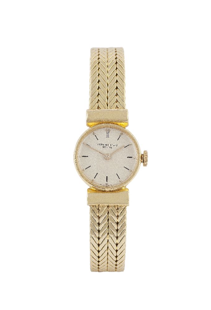 A Lady's 18 carat gold wristwatch by Patek Philippe, the circular silvered dial with black baton