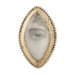 A late 18th Century lover's eye brooch, the oval ivory plaque depicting a hand painted eye to a gilt