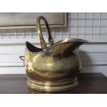 A brass coal scuttle.