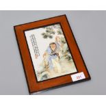 A Chinese porcelain famille rose plaque mounted in a wooden frame decorated with Liu Hai and the