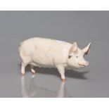 A Beswick china figure of a cream coloured pig, printed Beswick mark and painted in black no. 29 and