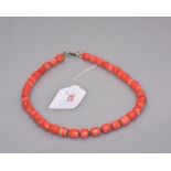 A Chinese coral necklace. Length 43cm