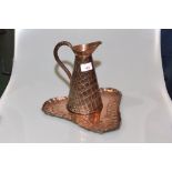 An Arts & Crafts copper water jug and triangular shaped tray (2)