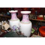 A large pair of Chinese famille rose porcelain baluster vases, each decorated with figures, iron red