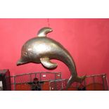 A large metal wall hanging of a dolphin