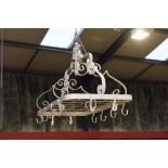 A painted wrought iron hanging pot rack