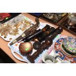 A tray including Oriental lacquer spill vases, carved tribal candlesticks, Turkish pistol etc