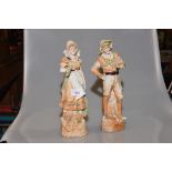 A pair of 19th century porcelain figures of a fisherman and his wife.