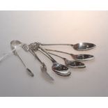 A set of six silver tea spoons tog. with matching sugar tongs, with pierced Gothic decoration,