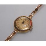 A 9ct gold Rolex lady's wristwatch circa 1940/50 on a 9ct gold bracelet strap, with stamped marks.