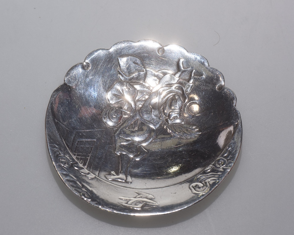 A Chinese white metal pin dish decorated with an erotic scene, 8cm