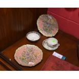 A pair of 20th Century Chinese plates decorated with floral decoration on a pink ground together