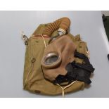 A World War II period gas mask in original canvas case.