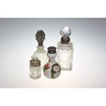 A group of four silver and white metal mounted scent bottles