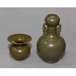 A Chinese porcelain twin-handled vase with a green glaze and impressed six character mark to base,