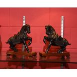 A pair of patinated bronze Arabian horse models, each mounted on a wooden plinth, 24.5cm high