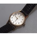 A vintage 9ct gold lady's Omega wristwatch, the case stamped 375, on a leather strap.